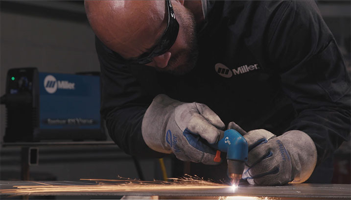 Man using a plasma cutting torch to cut metal